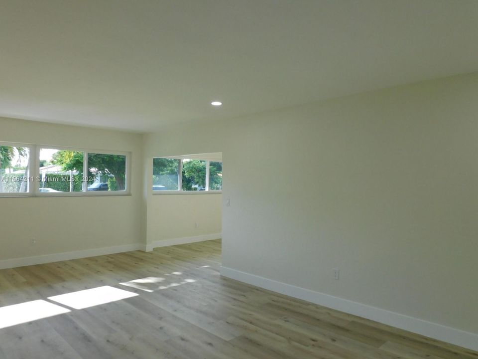 Living room leads to dining room which opens directly onto open kitchen concept.