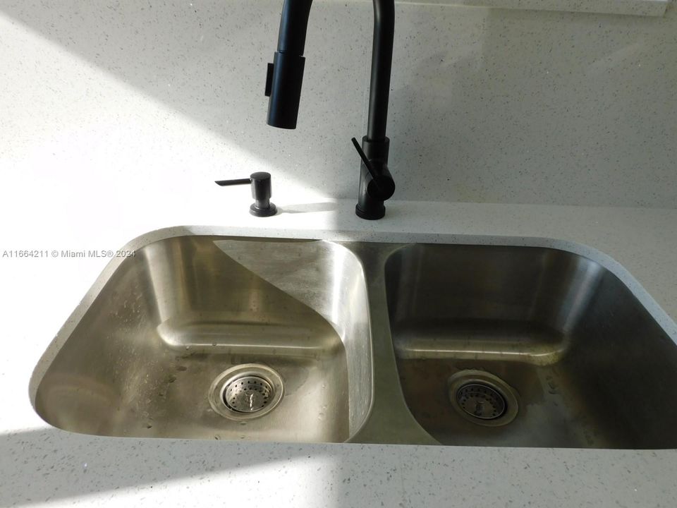 SS undermount sink with soap dispenser.