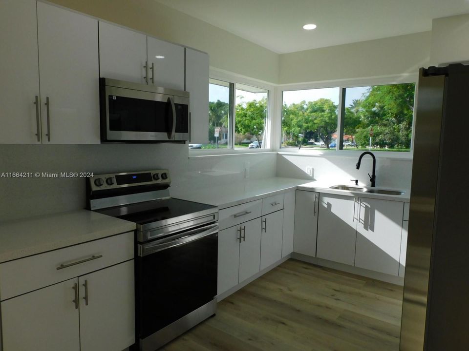 Brand New Kitchen with Quartz counter tops and backsplash.