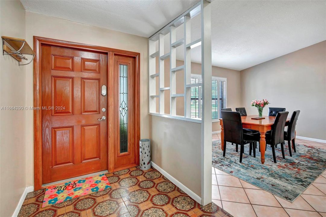 Beautiful front door with lited glass and ring doorbell.