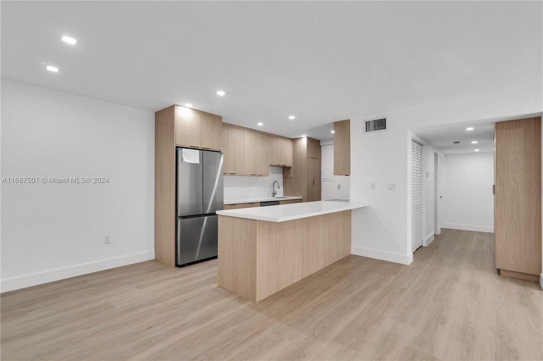 Snack bar provides additional seating - Washer/dryer enclosed in new cabinetry