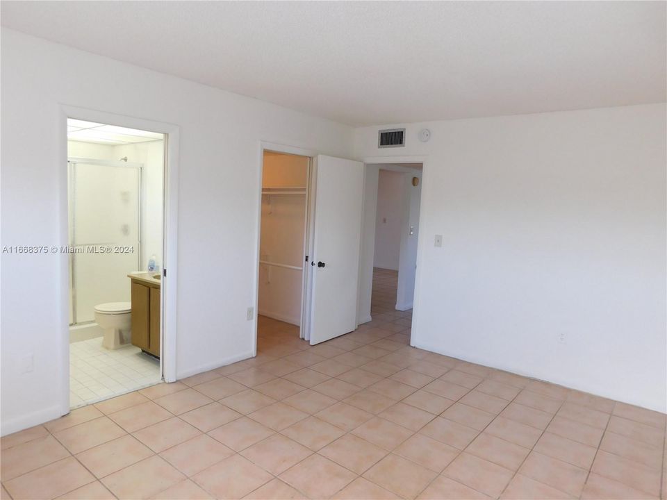 master bedroom with walk in closet