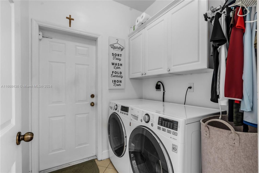 laundry area with cabinets