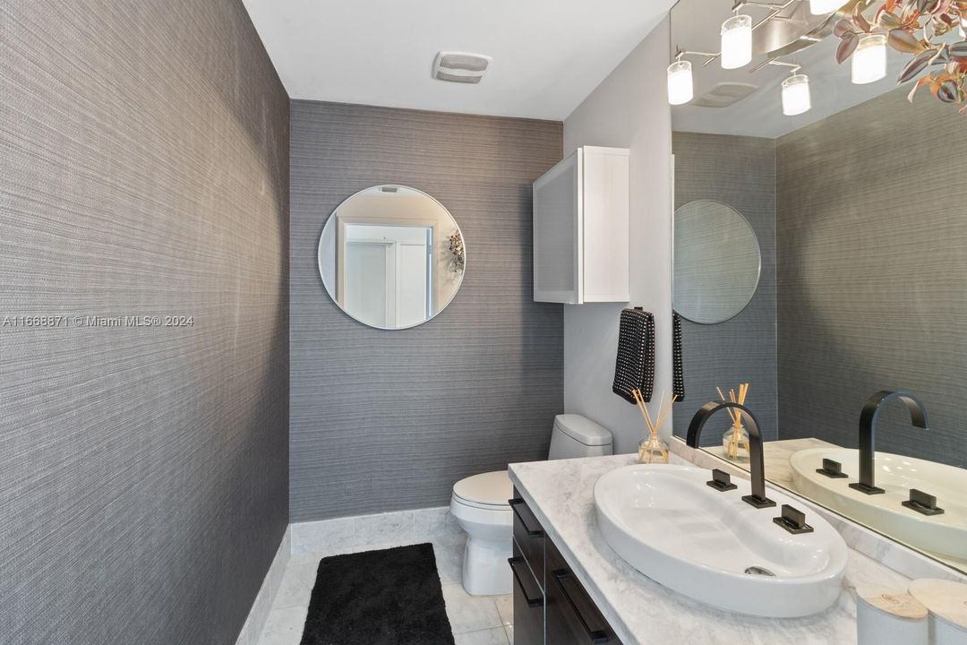 Guest Bathroom. Wall paper, marble top, marble floor.