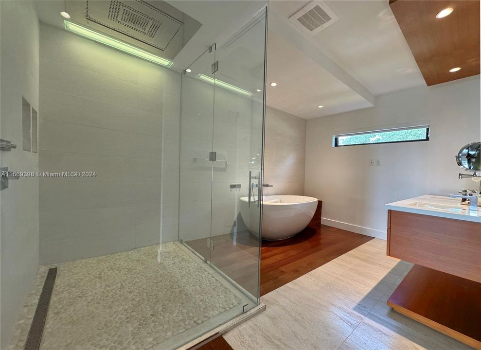 All bathrooms have ceiling mounted rainfall shower. Master bathroom has a stand alone jacuzzi tub, a separate shower with a unique chromotherapy ceiling mounted rain shower by DORN BRACHT.