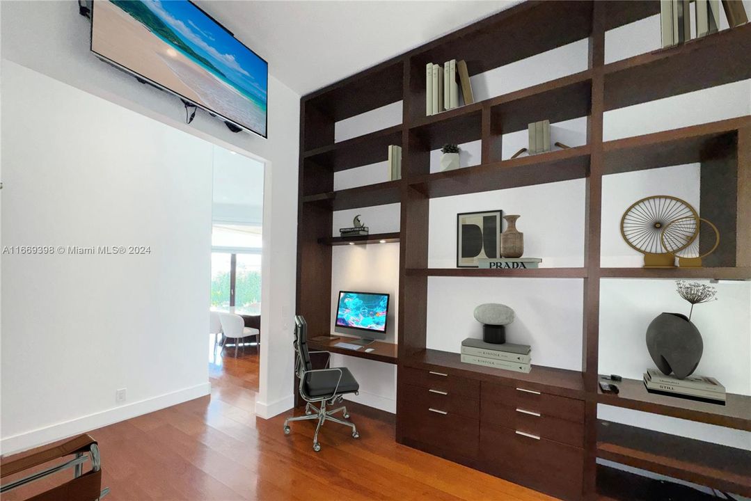 Office has a custom made built-in library, and a wall mounted TV that will stay.