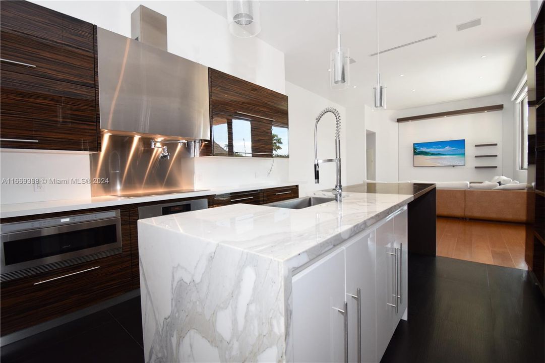 Subzero Refrigerator and Subzero wine cooler, Wolf stove and oven, Miele dishwasher, microwave, and professional grade range hood with exterior venting. Quartz Counter and custom-made cabinets