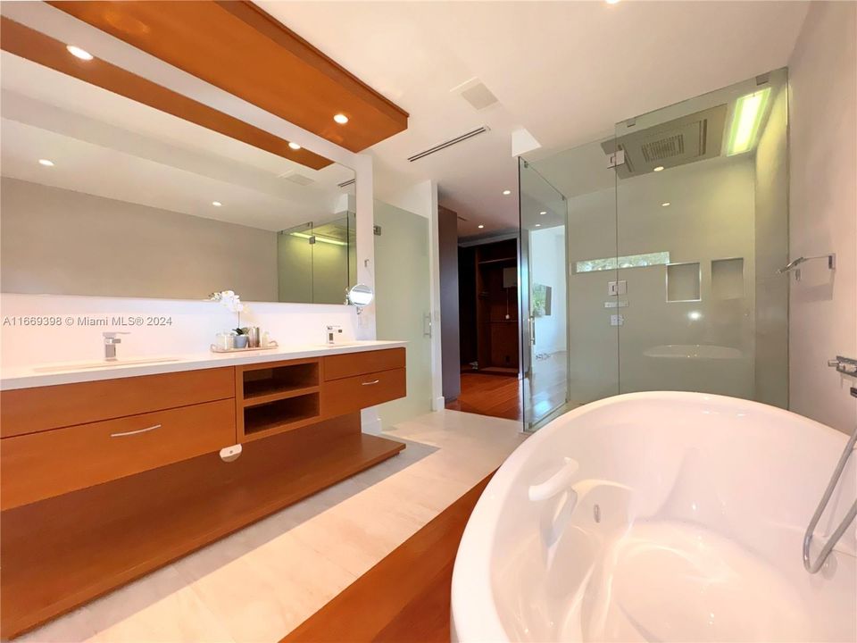 All bathrooms have ceiling mounted rainfall shower. Master bathroom has a stand alone jacuzzi tub, a separate shower with a unique chromotherapy ceiling mounted rain shower by DORN BRACHT.