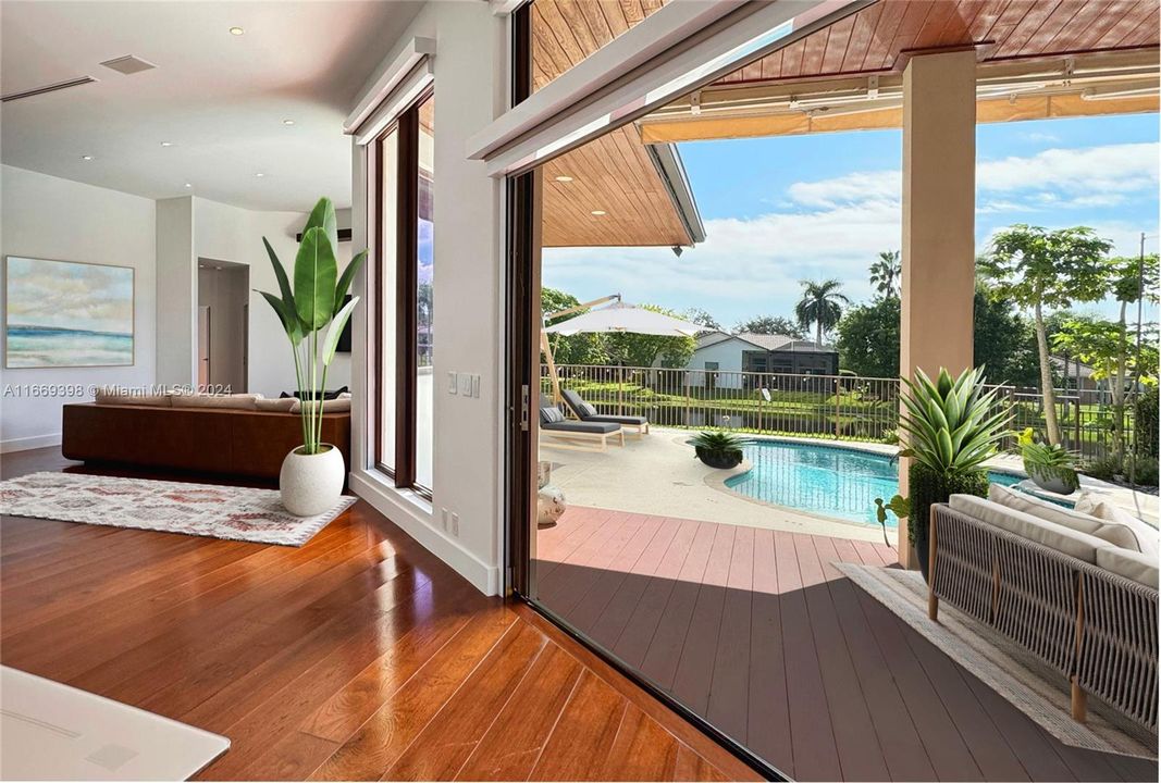 Dining and living areas offer a unique foldable hurricane impact glass door that opens up into the exterior kitchen, making the outdoor blend in with the indoor. All closets are custom build with oak veneer finish.