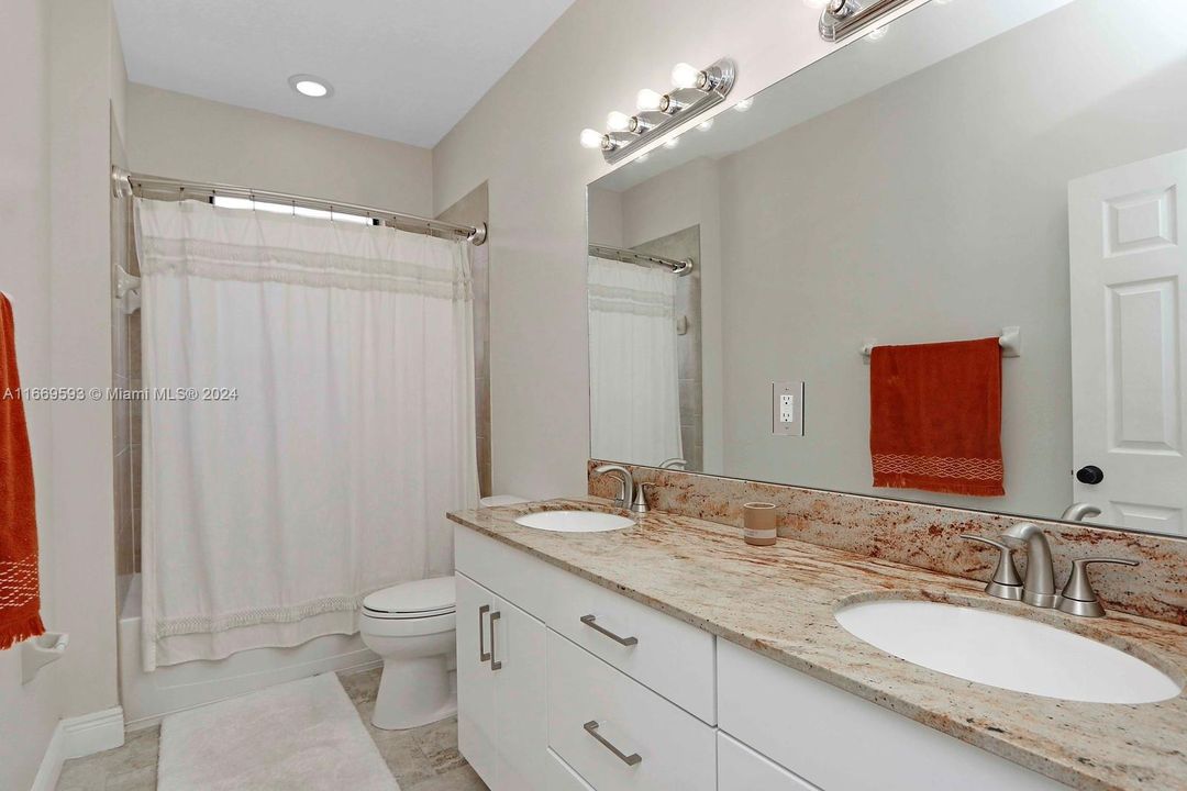 Hall bath, dual sinks tub shower combo.