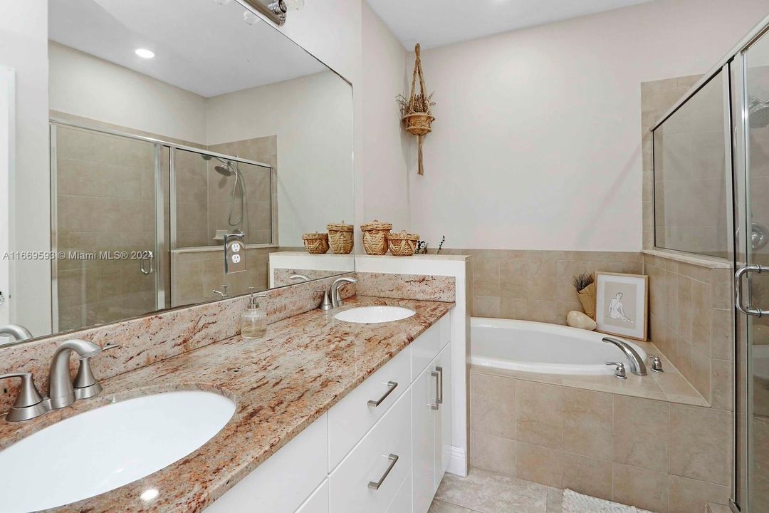 Master bath with his and hers sinks, separate tub and shower.