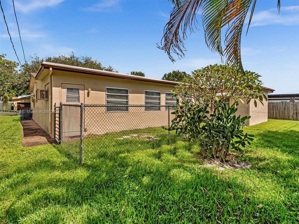 backyard has a small fenced in area perfect for a dog run