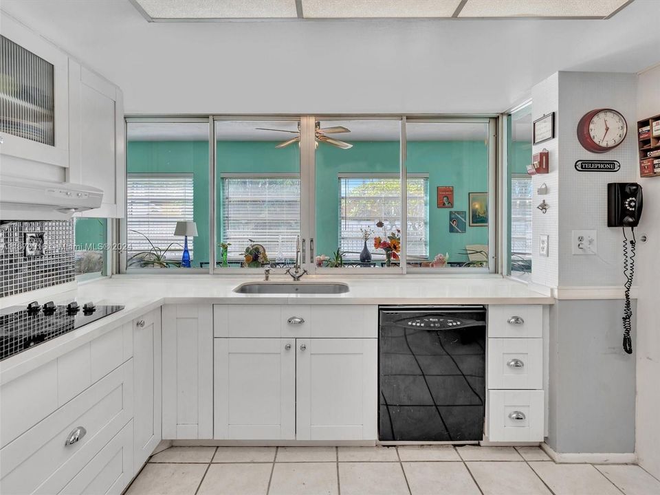 Kitchen features a sliding window out to the Florida Room - perfect for entertaining or keeping an eye on the kids!