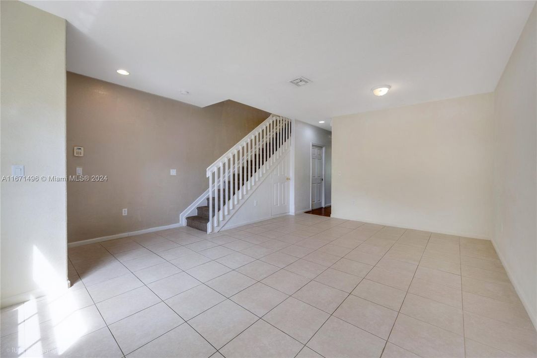 Step into the spacious living area with tile flooring and ample lighting.