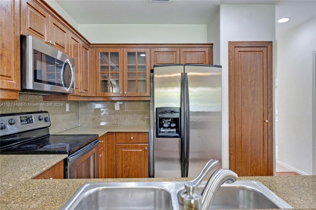 The kitchen is a chefs dream with ample counter space and beautifully upgraded custom cabinetry with stainless steele appliances.