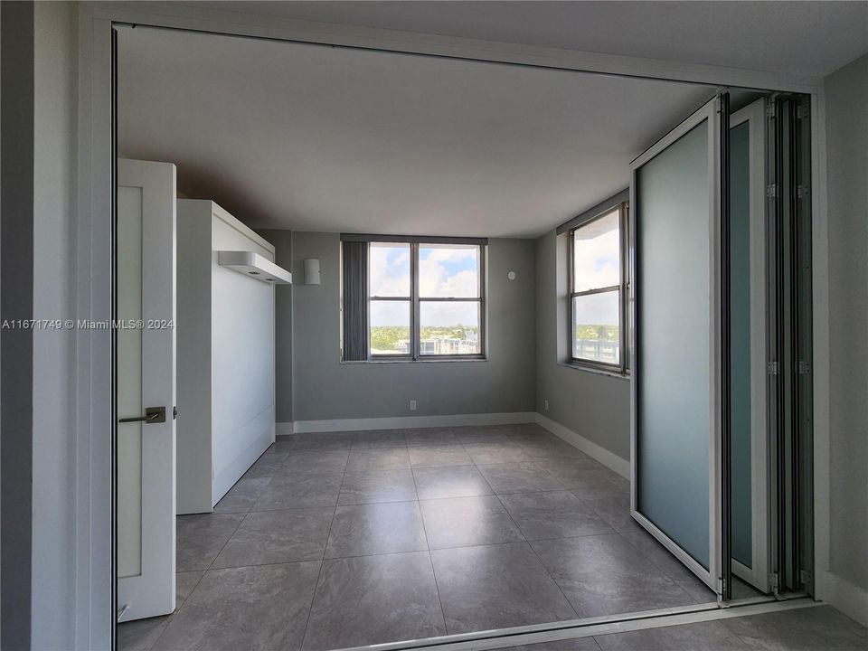 CONVERTIBLE room with glass/metal doors closed to separate the room from the living room. There is as separate entry door to room. See other pictures.