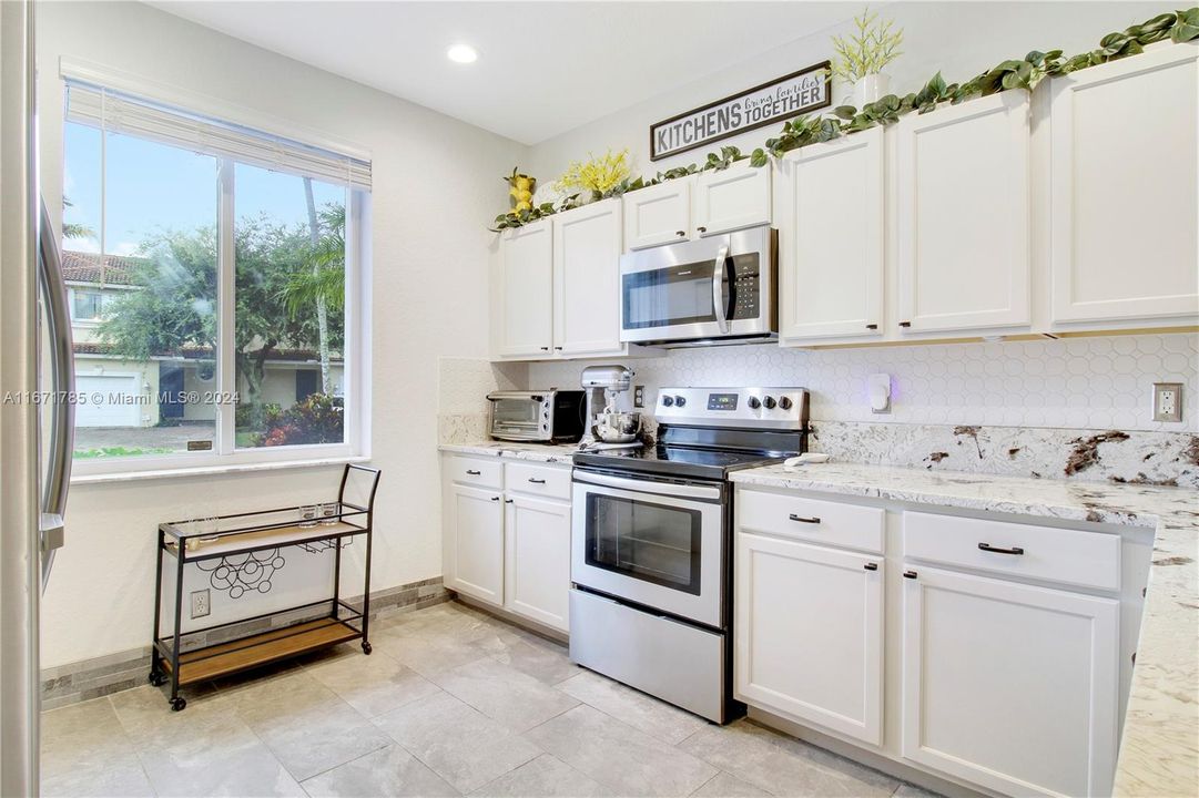 Tastefully updated kitchen with beautiful granite & SS appliances