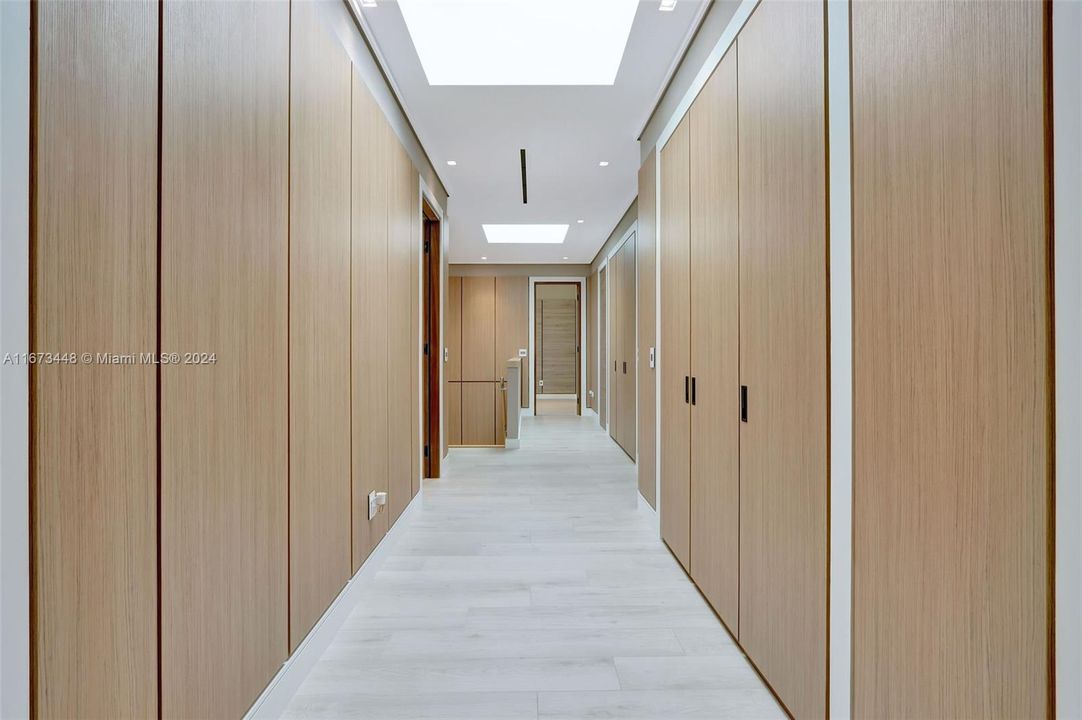 Hallway with storage to bathrooms