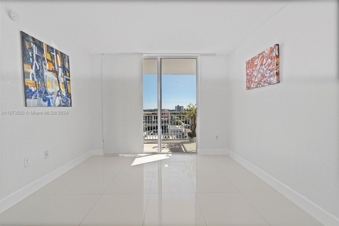 View of living room area.  Sliding doors to balcony, looking east.