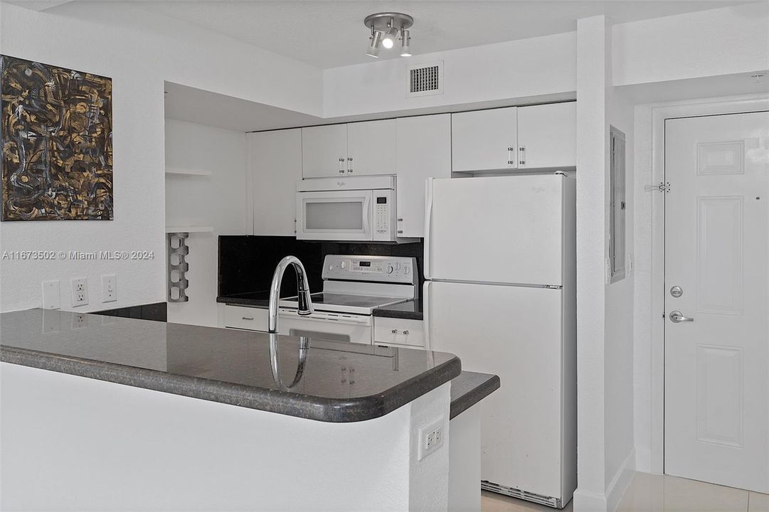 Granite kitchen counter on foreground.