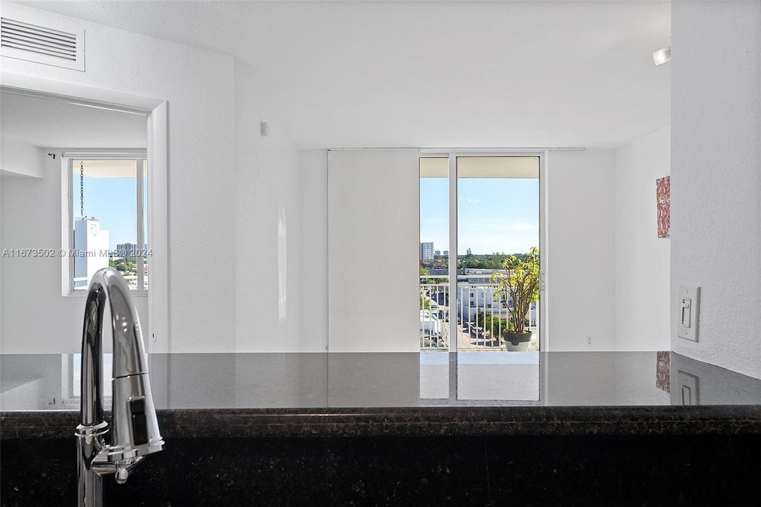 Kitchen, east view through sliding door provides morning light.