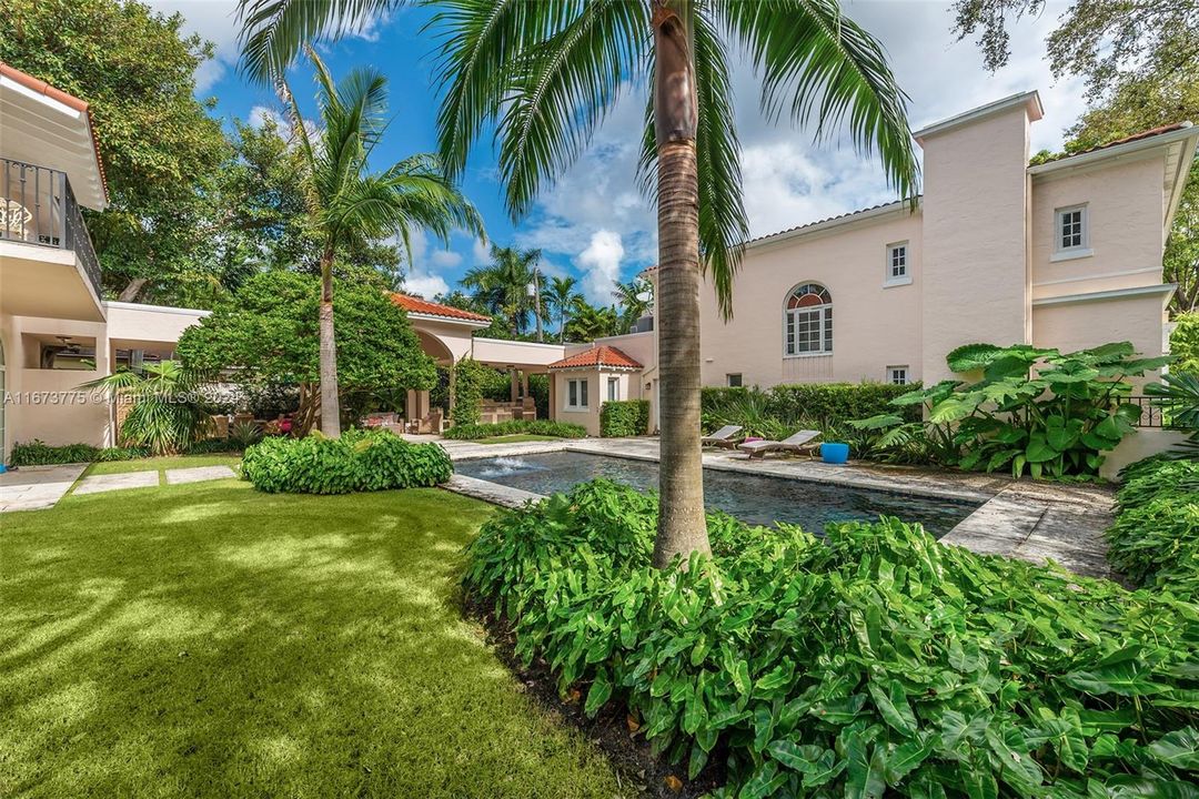 Backyard has an outdoor koi pond with waterfall feature