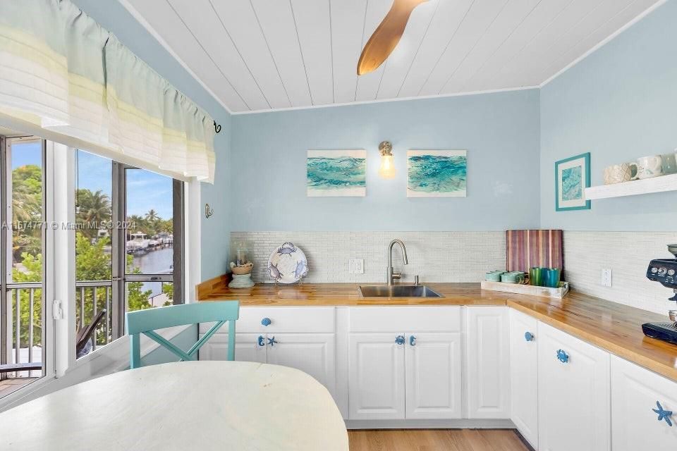 Set up for entertaining, this wet bar kitchen walks right out to the pool