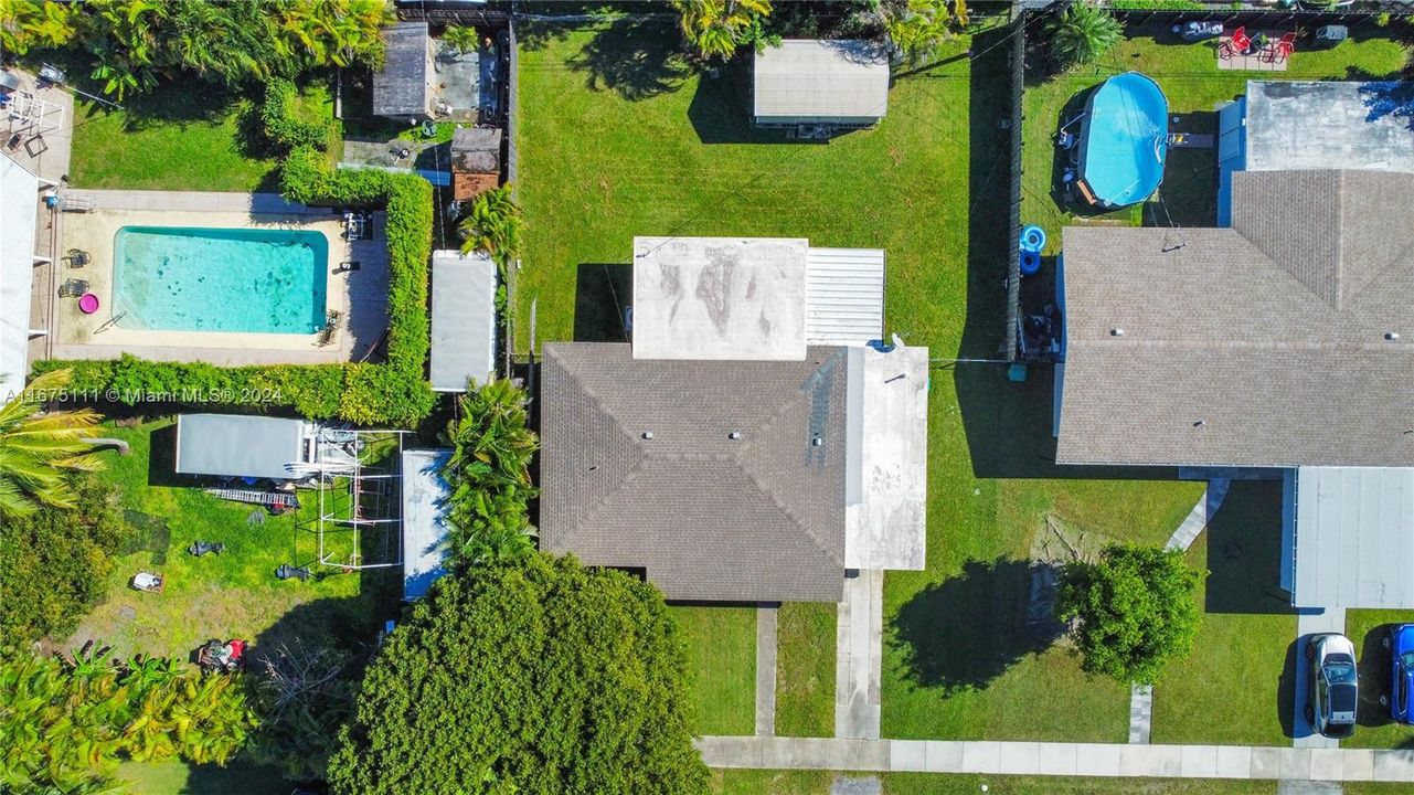 Aerial view showing the large fenced lot with room for a pool