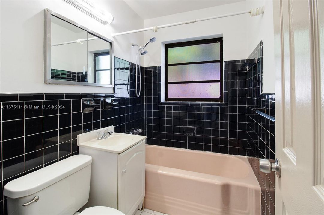 Bathroom for the 2 bedrooms on one side of the house. The original tile is in pristine condition!