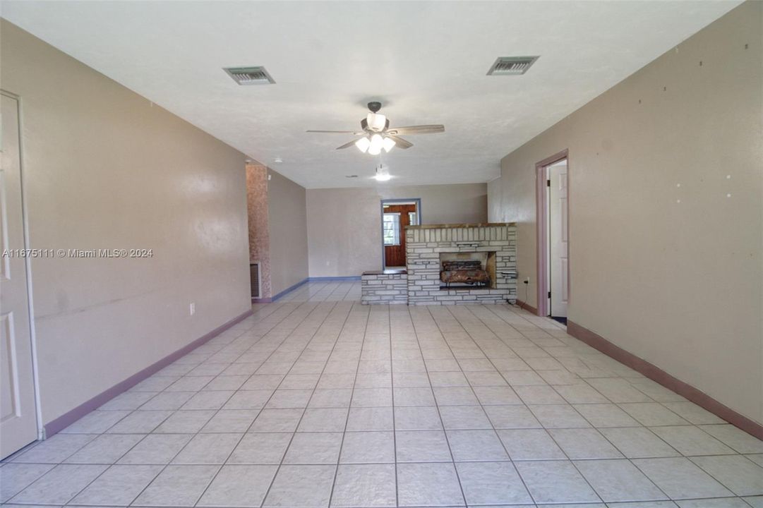 View from the entrance to the spacious living room with a rock fireplace