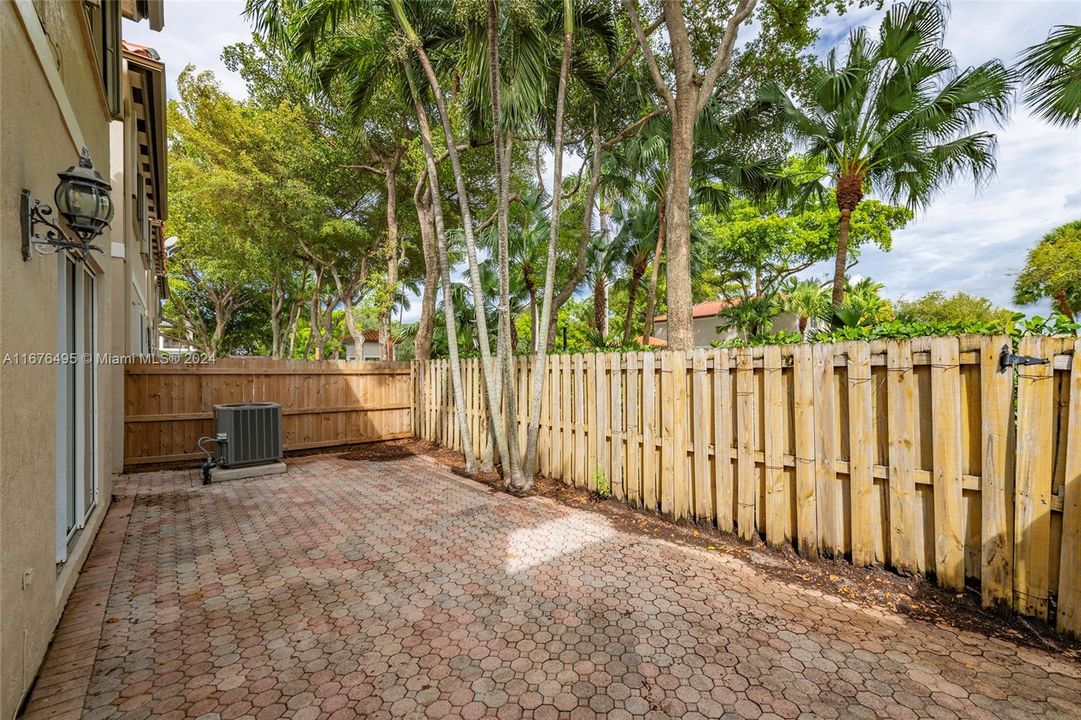 Large back patio with storage room.