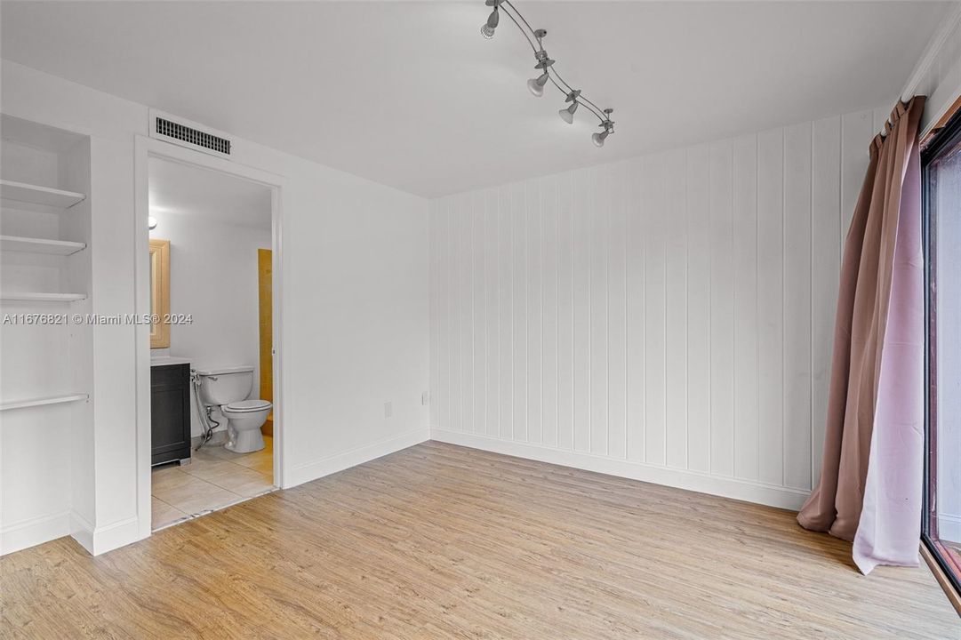 3rd bedroom with its own bathroom and sliding doors facing the front patio.