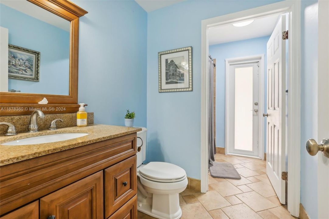 Guest bathroom and cabana door to pool area