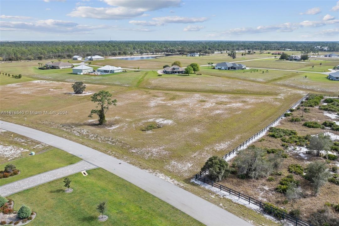 Southeast aerial view of 4013 Camp Shore Drive's 2.4 acre lot bordering the 19 acre preserve located within the prestigious gated community of Highland Lakes Reserve. Experience the tranquility and security of this gated community, consisting of 155 homesites between 1 and 5 acres in size, designed to embrace the natural beauty of Central Florida.