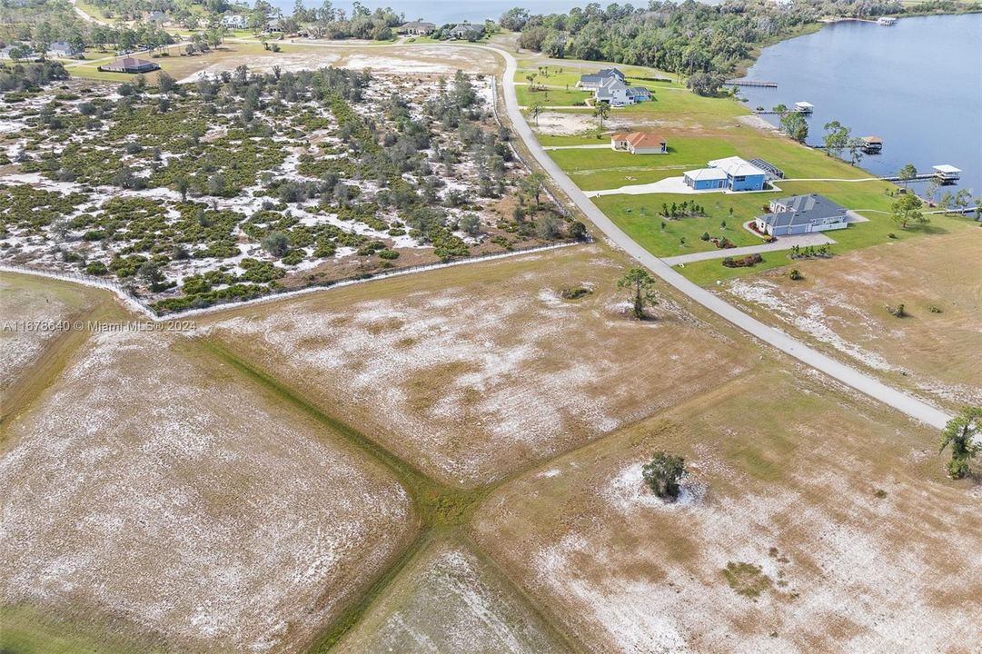 Aerial view of 4013 Camp Shore Drive homesite and 19 acre preserve adjacent to the property. Looking west towards Lake Ruth in the background, which is also a private lake that is part of the private Highland Lakes Reserve community.