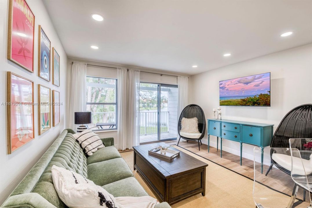 Sliding doors leading to balcony with peaceful water view.