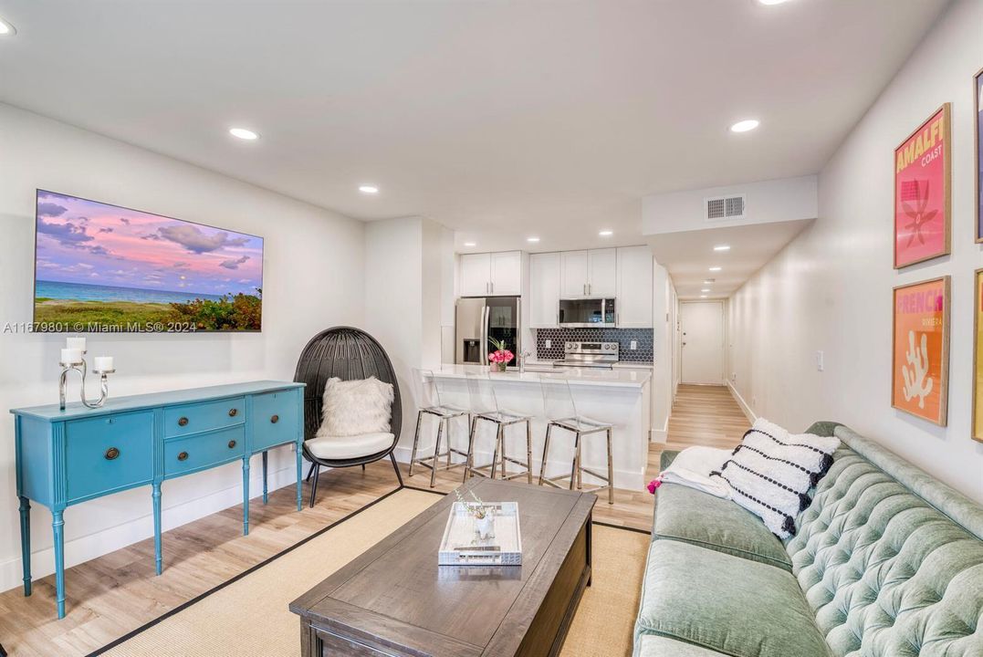 Main living area with open kitchen and comfortable furnishings.