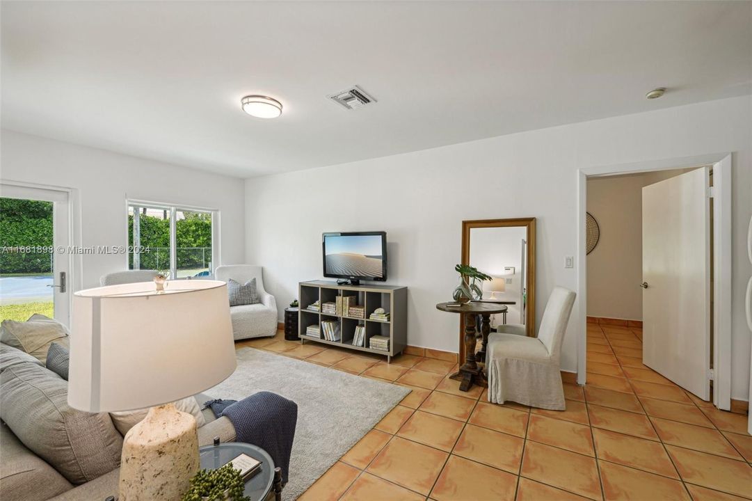 Guest suite living area with french doors to garden and tennis