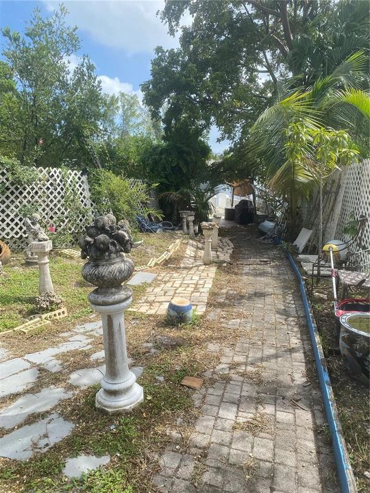 SOUTH SIDE OF HOME WITH A WIDE PATHWAY