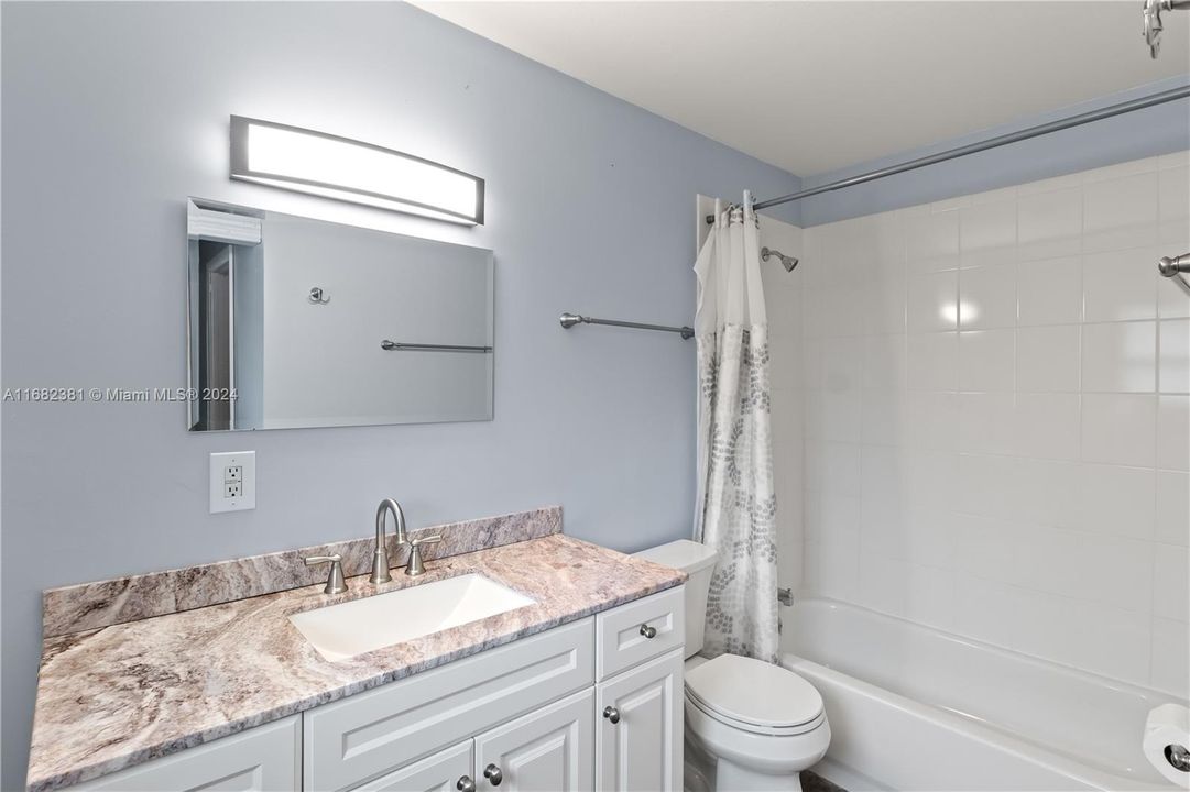 Master Bath with tub shower combination and large vanity. Beautiful granite vanity also!