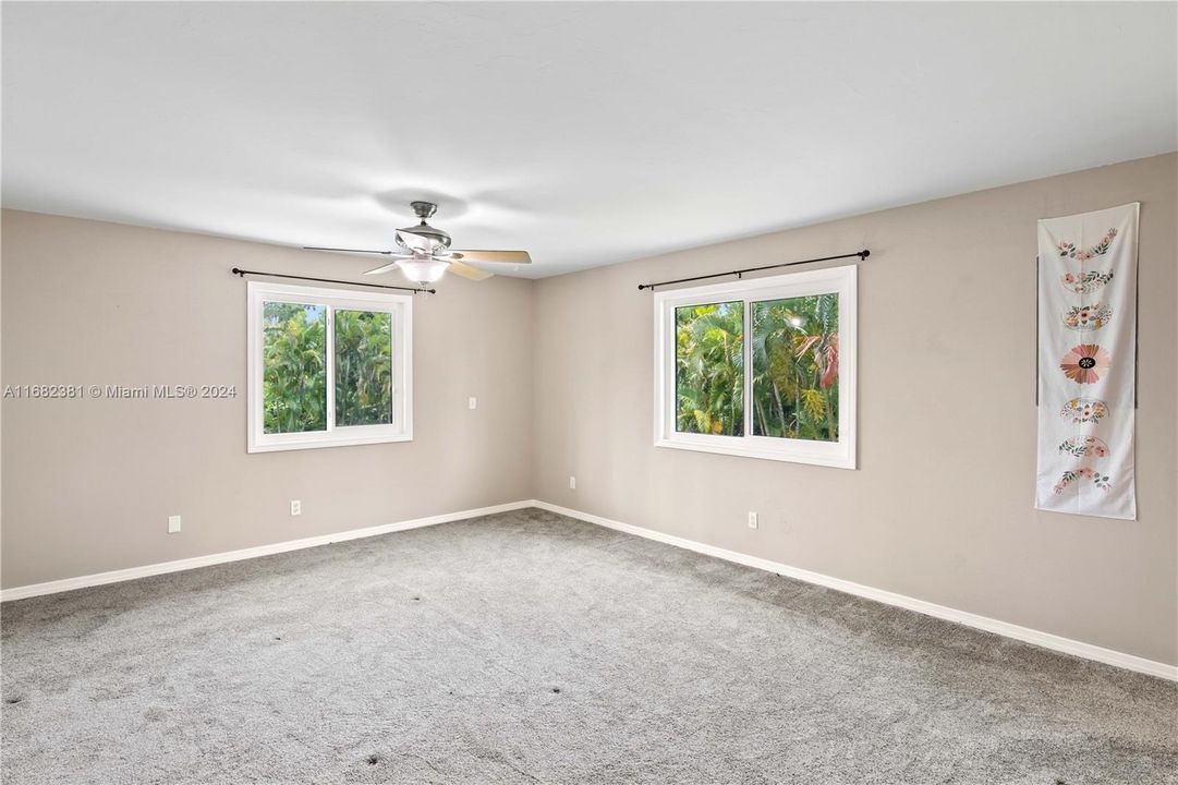 Master bedroom with carpet and ceiling fan - more natural light and gorgeous views out the window?