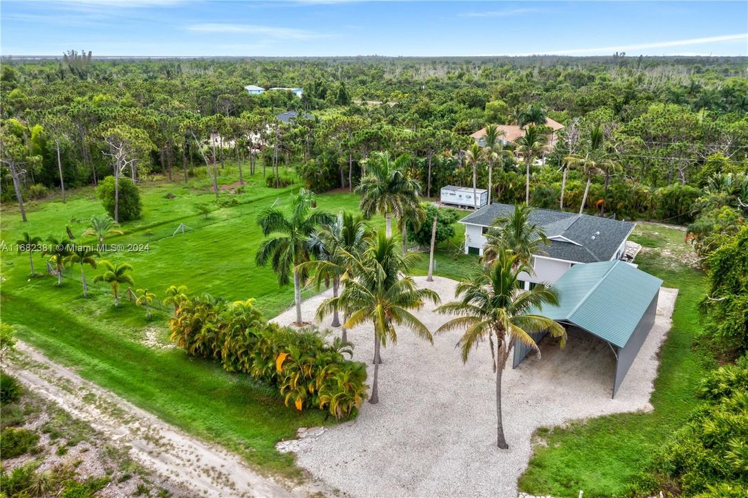 South facing backyard is perfect to enjoy the beautiful sunshine. HUGE oversized driveway can easily accommodate multiple cars and as an added bonus the metal building could be converted into closed space - whether it is a garage or workshop, there are so many additional options!...