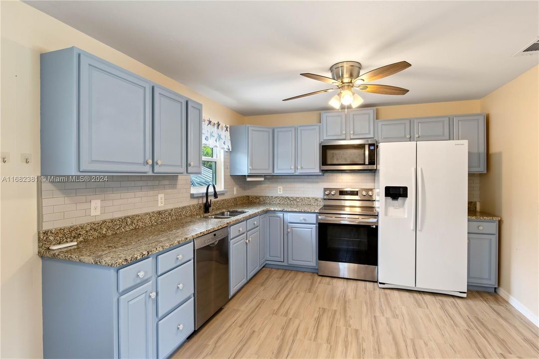 Kitchen with granite countertops and lots of counter space.