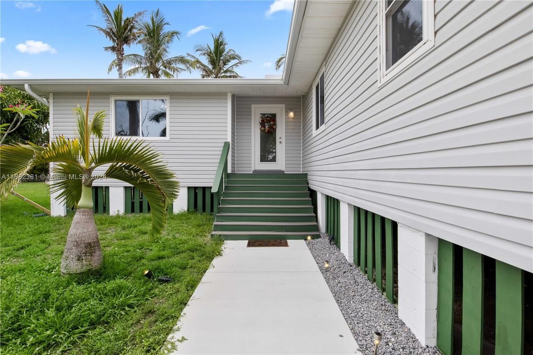 Curb appeal alert! Beautiful trex deck stairs with impact windows throughout the home and a glass door to allow the natural light in!