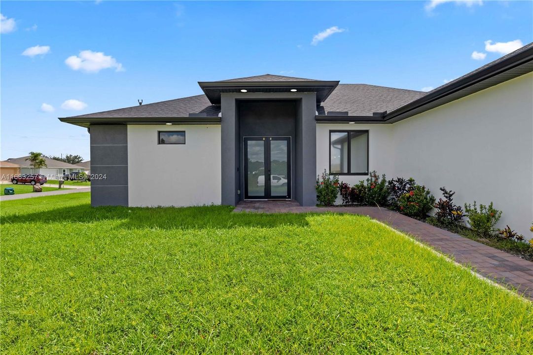 Property entrance featuring a lawn