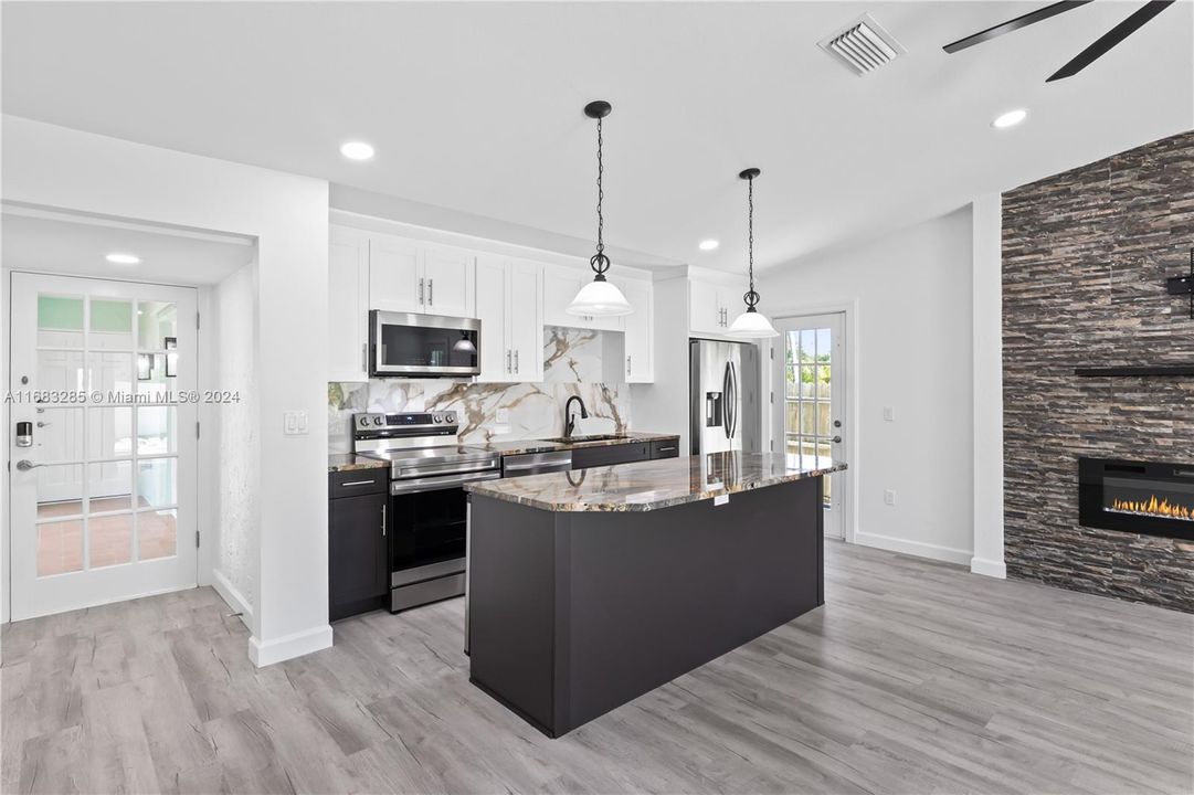 Wide angle of the kitchen - plenty of cabinet and counter space!