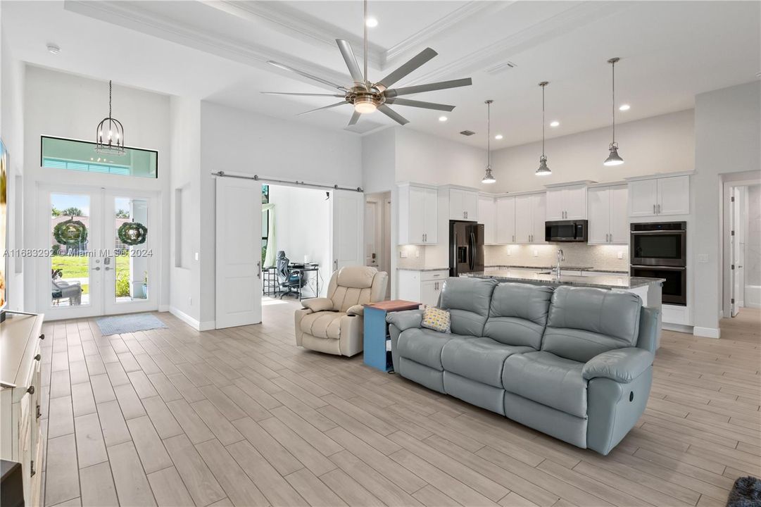 Living room is filled with natural light and room! Double barn doors lead to the office. Open concept floor plan with stunning gourmet kitchen!