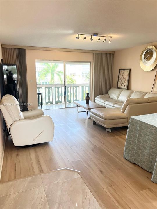 Large living and dining room receives a great deal of natural sunlight.Very spacious screened in balcony & hurricane shutters. Beautiful view overlooks the expansive green courtyard and mature palm trees.