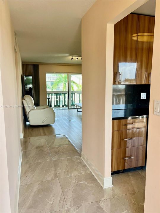 Entry foyer and kitchen both feature beautiful modern oversized large tile.Entry foyer has storage closet.