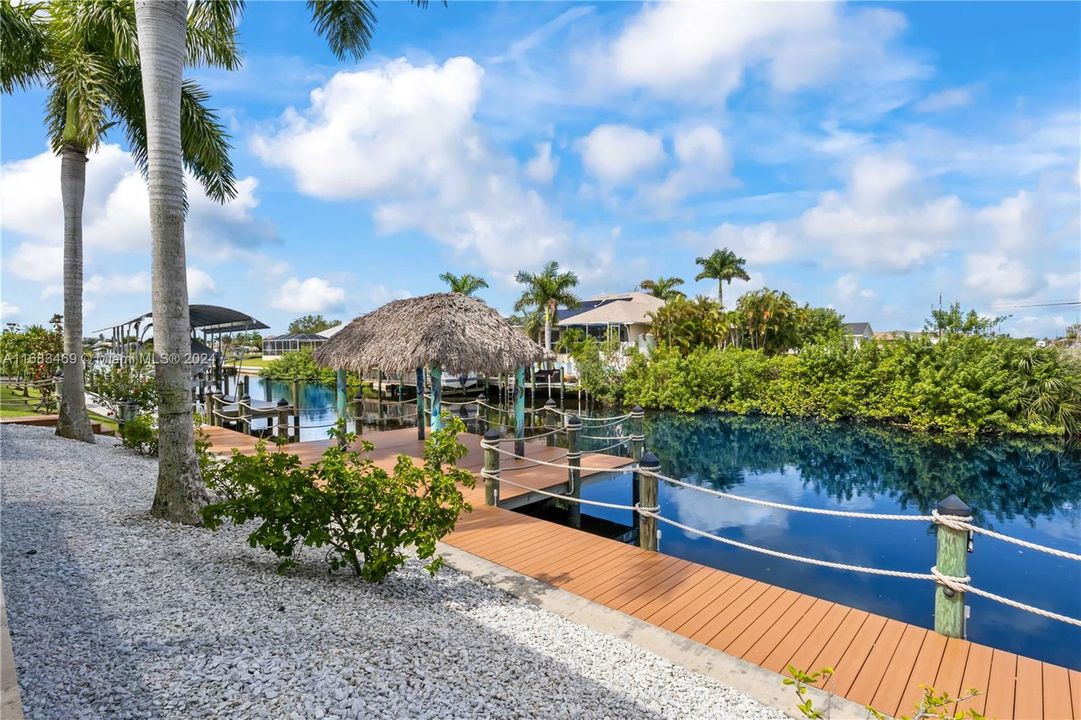 The Captain's walk runs the length of the home and centers on a large dock with super sized tiki hut!